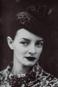 woman wearing animal print cocktail hat